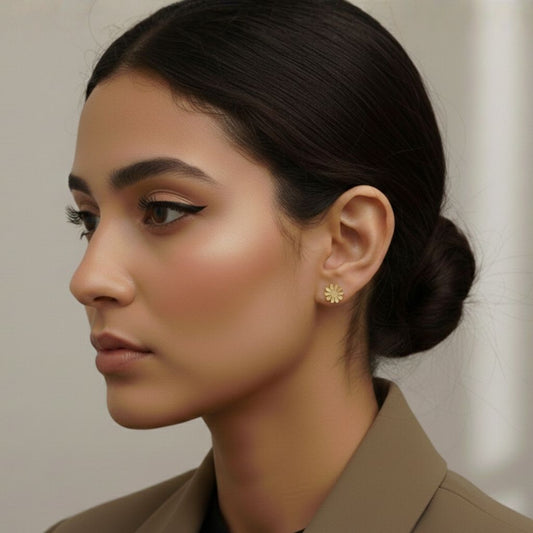 Abidii Blossom Studs – small flower-shaped stud earrings on a model's ear, showing their delicate floral design