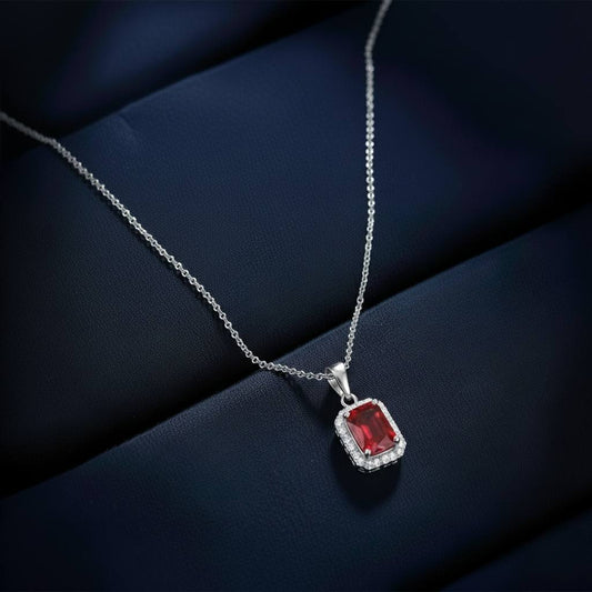 Abidii Regalia Set – halo pendant necklace with matching stud earrings displayed on a soft fabric surface, showing their refined, delicate sparkle.