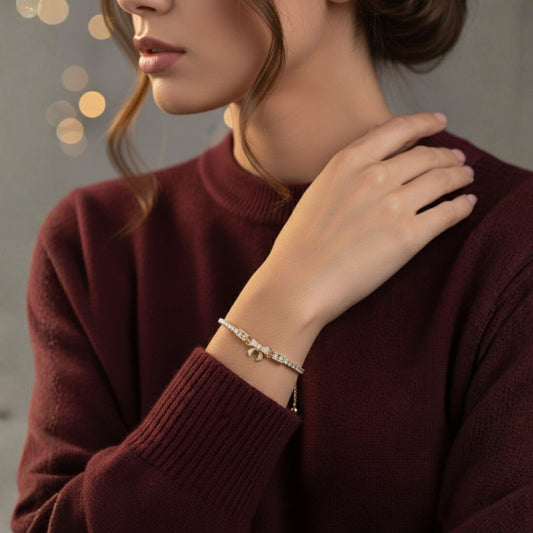Abidii Stardust Ribbon Bracelet – rose-gold-tone bracelet with pavé bow center and slider closure,styled by a model
