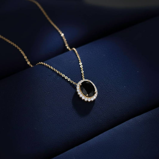 Abidii Eternity Set – oval halo pendant necklace with matching oval stud earrings displayed on a soft fabric surface, showing their timeless, luminous design.