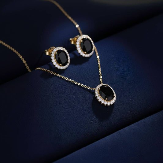 Abidii Eternity Set – oval halo pendant necklace with matching oval stud earrings displayed on a soft fabric surface, showing their timeless, luminous design.