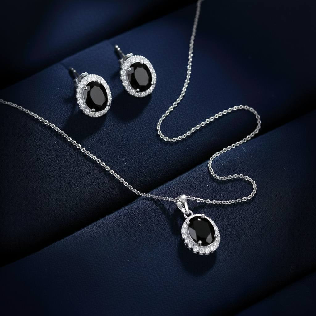 Abidii Eternity Set – oval halo pendant necklace with matching oval stud earrings displayed on a soft fabric surface, showing their timeless, luminous design.