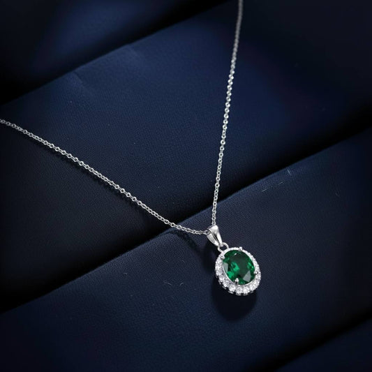 Abidii Eternity Set – oval halo pendant necklace with matching oval stud earrings displayed on a soft fabric surface, showing their timeless, luminous design.