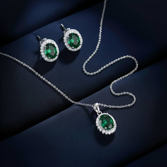 Abidii Eternity Set – oval halo pendant necklace with matching oval stud earrings displayed on a soft fabric surface, showing their timeless, luminous design.