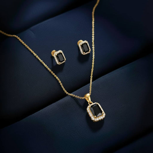 Abidii Regalia Set – halo pendant necklace with matching stud earrings displayed on a soft fabric surface, showing their refined, delicate sparkle.