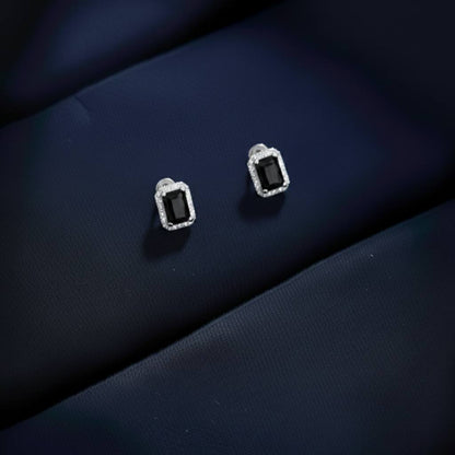 Abidii Regalia Set – halo pendant necklace with matching stud earrings displayed on a soft fabric surface, showing their refined, delicate sparkle.