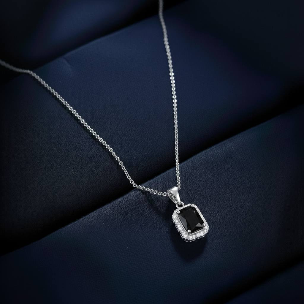 Abidii Regalia Set – halo pendant necklace with matching stud earrings displayed on a soft fabric surface, showing their refined, delicate sparkle.