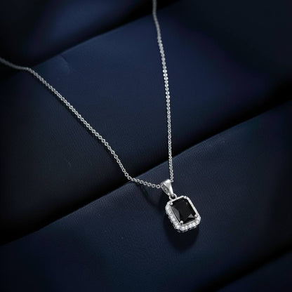 Abidii Regalia Set – halo pendant necklace with matching stud earrings displayed on a soft fabric surface, showing their refined, delicate sparkle.