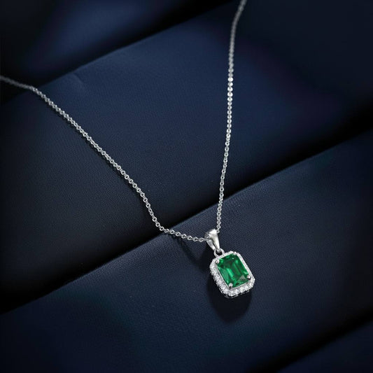 Abidii Regalia Set – halo pendant necklace with matching stud earrings displayed on a soft fabric surface, showing their refined, delicate sparkle.