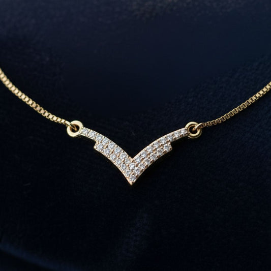 Abidii Vivid Bracelet – slim gold-tone bracelet with a V-shaped pavé center bar, displayed on dark fabric, showing its modern, minimal sparkle.