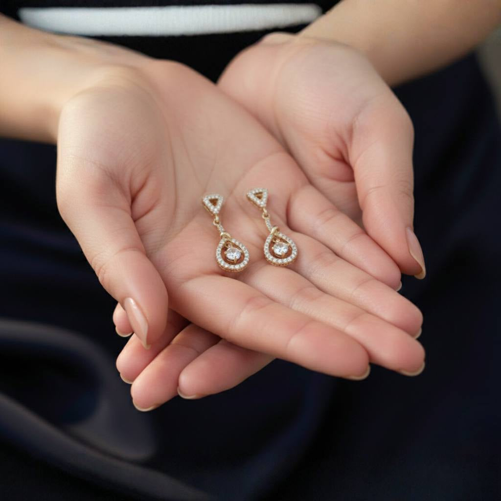 Abidii Zenith Set – teardrop halo pendant necklace with matching drop earrings displayed on dark, folded fabric, showing their luminous stones and elegant, elongated design.